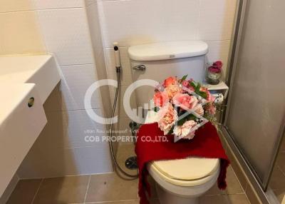 Decorated bathroom toilet with floral arrangement