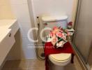 Decorated bathroom toilet with floral arrangement