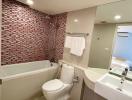 Modern bathroom with mosaic tile wall and white fixtures