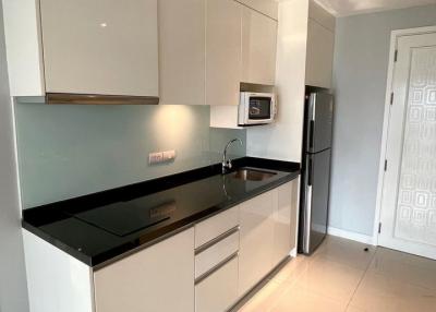 Modern kitchen with white cabinetry and stainless steel appliances