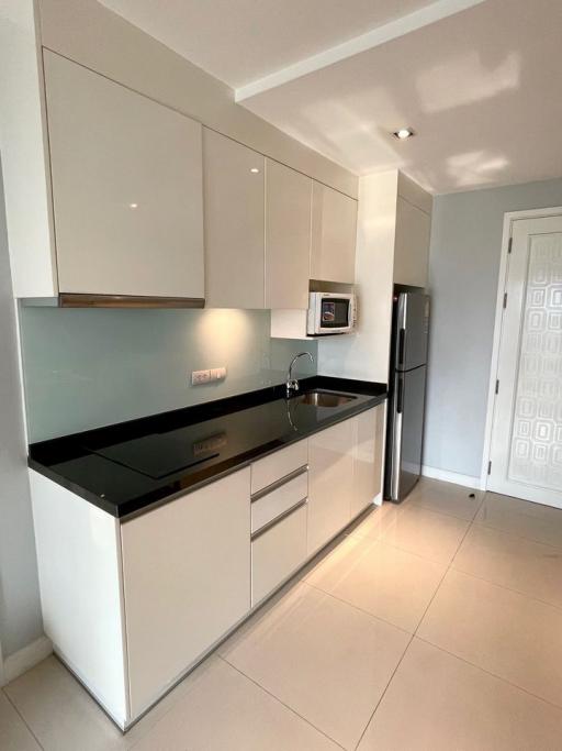 Modern kitchen with white cabinetry and stainless steel appliances