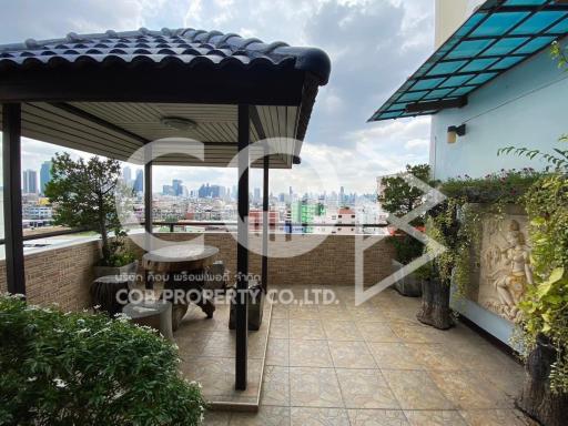 Spacious balcony with city view and artistic decoration