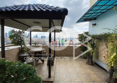 Spacious balcony with city view and artistic decoration
