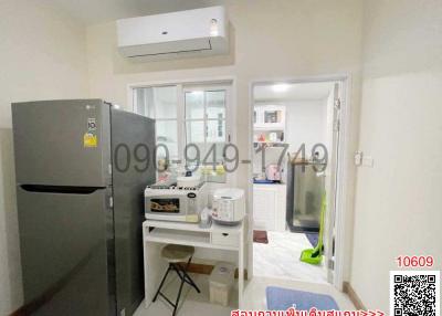 Compact modern kitchen with appliances and access to laundry area