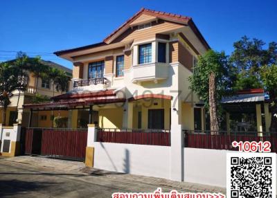 Spacious two-story residential house with a brown tiled roof and a gated entrance