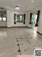 Spacious unfurnished living area with large windows and tiled flooring