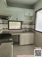 Compact kitchen with light wood cabinets and granite countertop