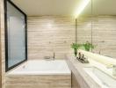 Modern bathroom with natural stone tiles and large mirror