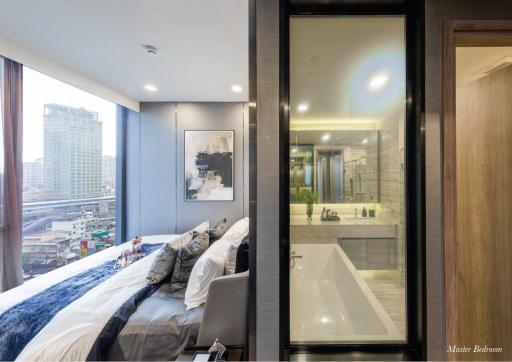 Modern bedroom with attached bathroom and city view
