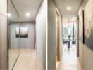 Modern hallway interior leading to a spacious dining area with city views