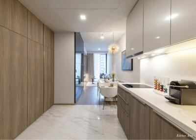 Modern kitchen with marble flooring extending to an open dining area with ample natural light