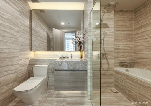 Modern bathroom with natural stone tiles, glass shower, and bathtub