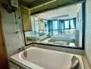 Modern bathroom with a bathtub and a view through a large window