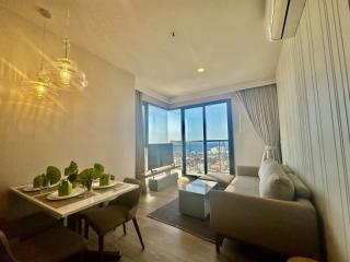 Modern living room with dining area and city view