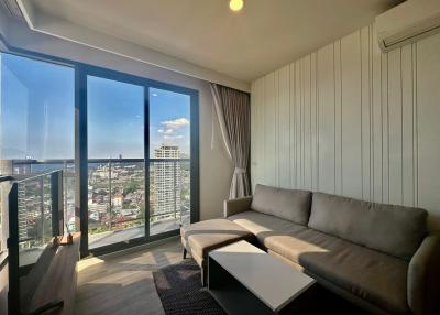 Bright and modern living room with large windows and city view