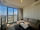 Bright and modern living room with large windows and city view