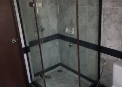 Modern bathroom with glass shower enclosure and toilet