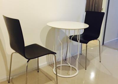 Small modern dining area with two chairs and a round table