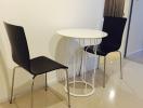 Small modern dining area with two chairs and a round table