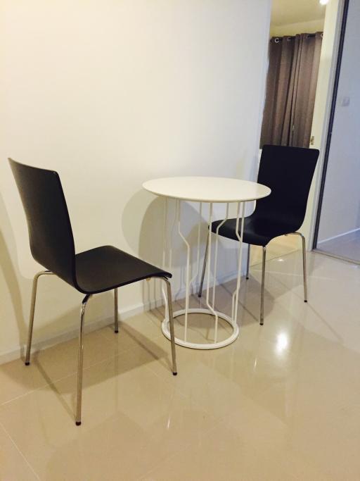 Small modern dining area with two chairs and a round table