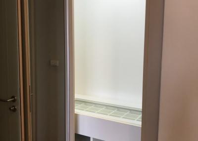 Frosted glass door leading to a room with built-in shelving