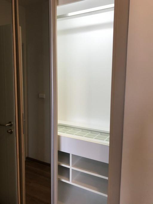 Frosted glass door leading to a room with built-in shelving