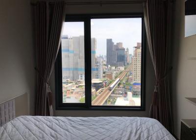 Bedroom with a view of the city skyline and transportation infrastructure
