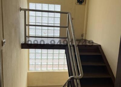 Modern staircase interior with metal banisters and large window