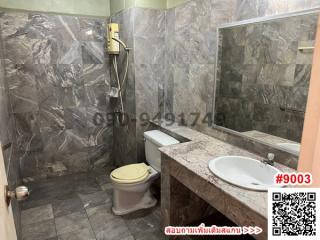 Modern bathroom with marble tiles and sophisticated fixtures