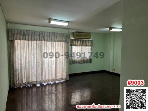 Spacious empty room with air conditioning and large windows