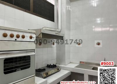 Compact white-tiled kitchen with vintage appliances