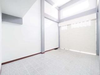 Bright empty room with large windows and white walls