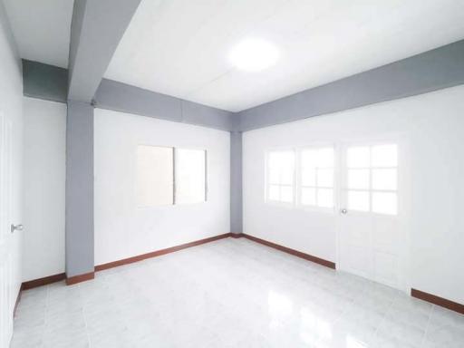 Spacious and bright empty bedroom with large windows