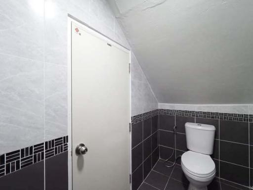 Modern bathroom interior with white and dark tiles