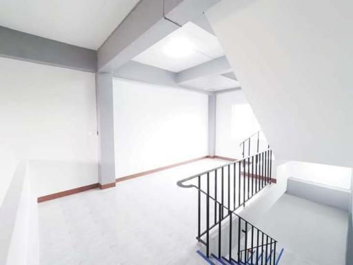 Bright and modern staircase area with white walls