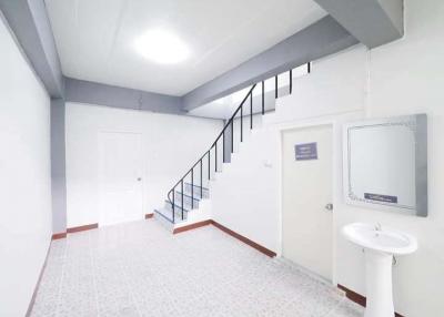 Interior staircase in a modern building with white walls and tiled flooring