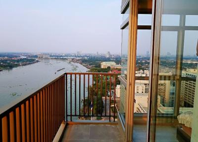 Spacious balcony with panoramic river view and city skyline