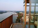 Spacious balcony with panoramic river view and city skyline