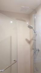 Modern bathroom with glass shower enclosure and rainfall shower head