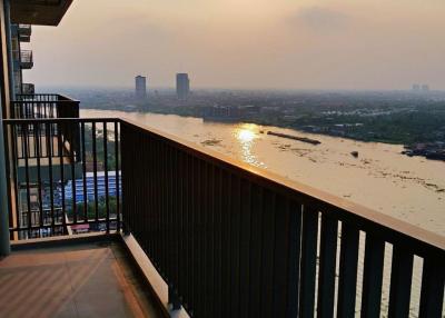 Spectacular sunset view from a high-rise apartment balcony overlooking the river