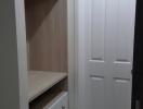 Cozy bedroom with built-in wardrobe and white door