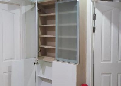 Built-in cupboard with open doors in a modern home interior