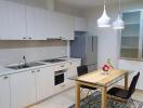 Modern kitchen with stainless steel appliances and a dining area