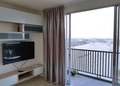 Bright and cozy living room with balcony access and scenic view