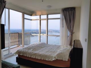 Spacious bedroom with large windows and panoramic city view