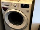 Modern LG washing machine in compact laundry space