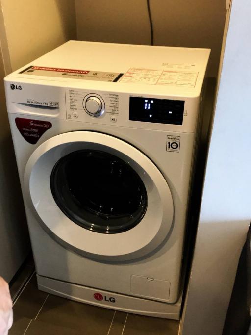 Modern LG washing machine in compact laundry space