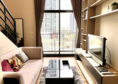 Modern living room with natural lighting and stylish furnishings