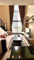 Modern living room with natural lighting and stylish furnishings