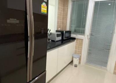 Modern kitchen with stainless steel appliances and tiled flooring